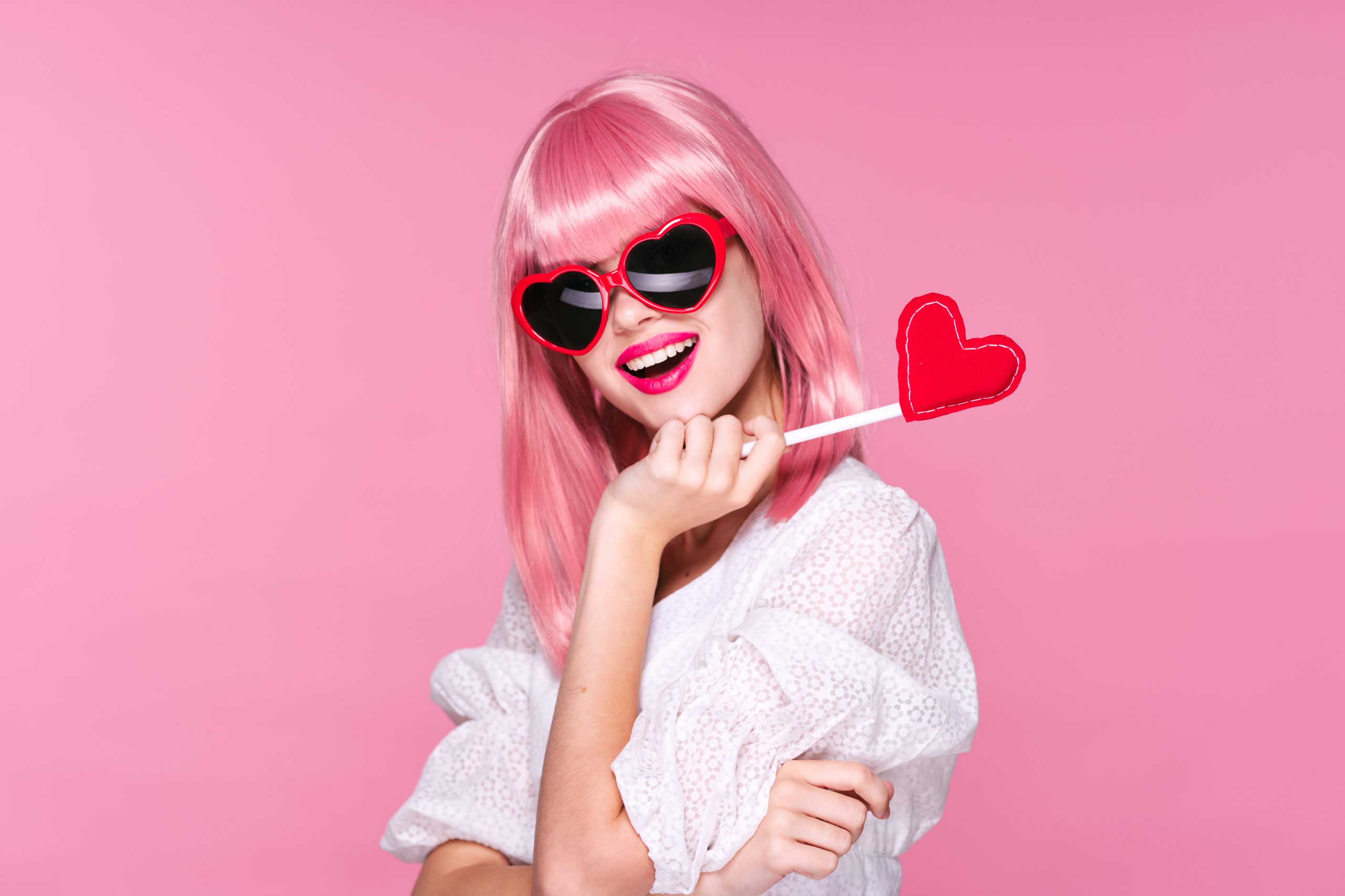 Woman,With,Pink,Hair,And,Sunglasses,Shows,A,Tissue,Heart