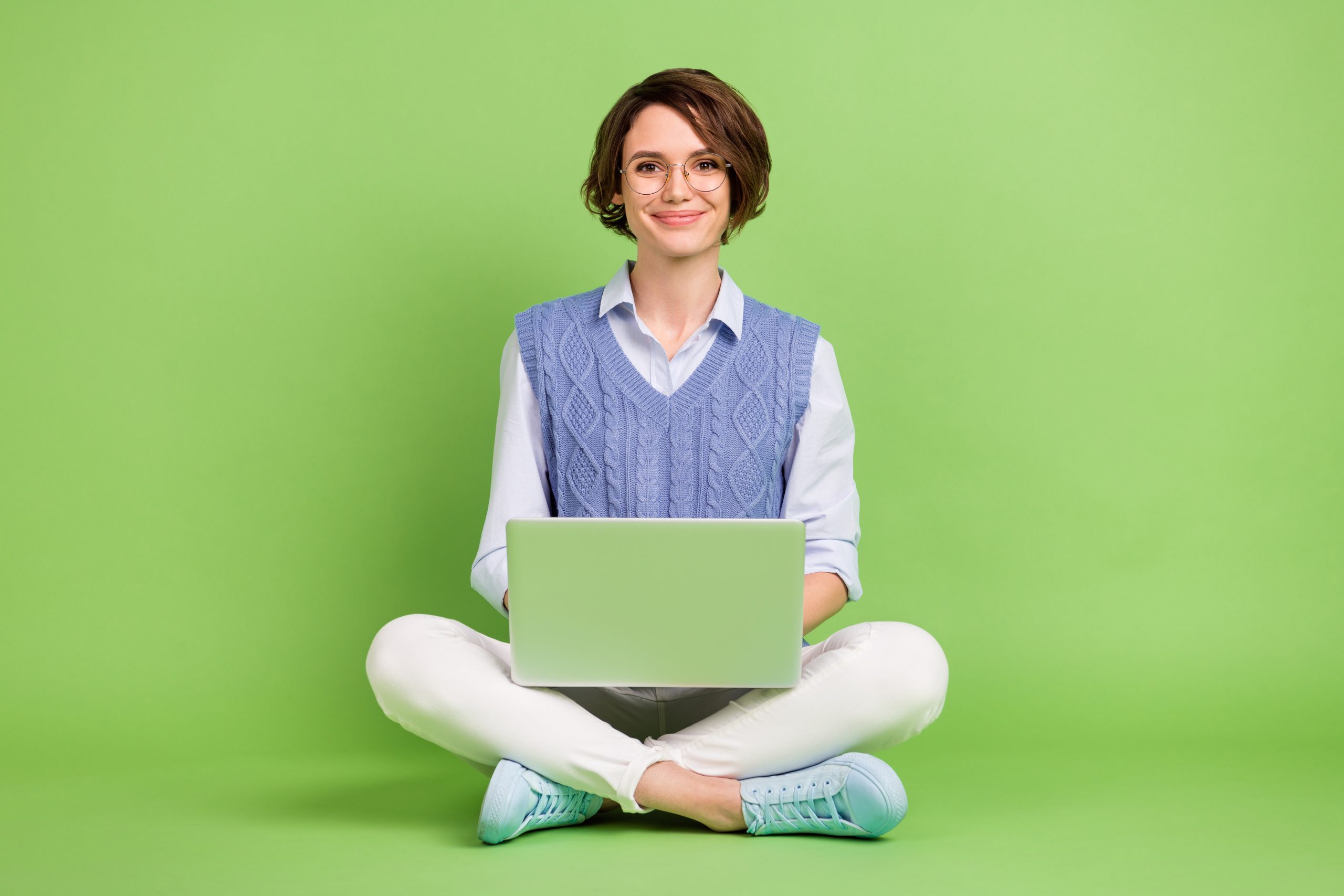 Portrait,Of,Attractive,Cheerful,Content,Girl,Sitting,Lotus,Position,Using