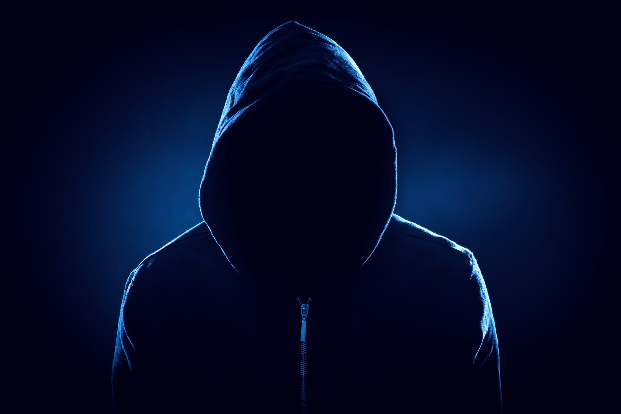Anonymous,Man,In,Hood,On,Black,Background,,Color,Toned