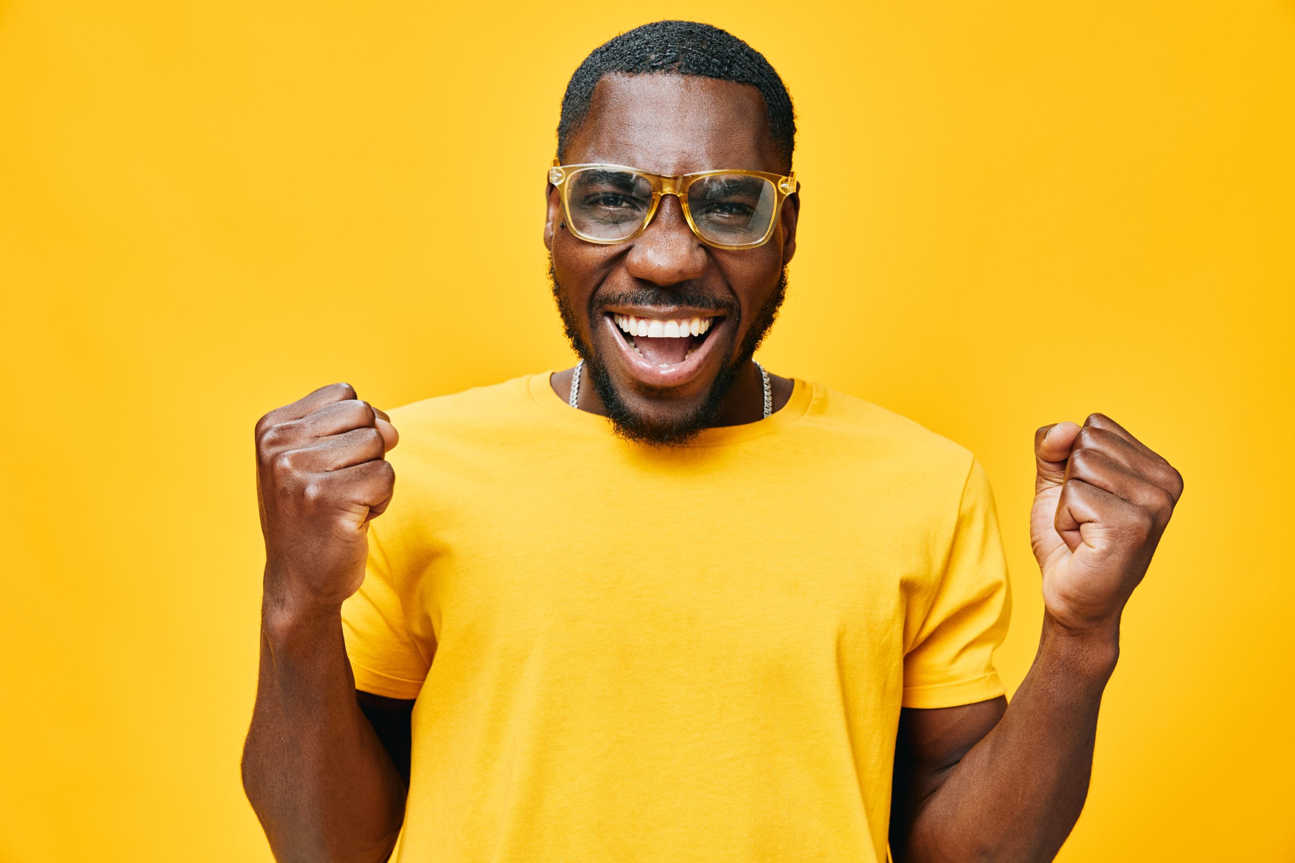Excited,Young,Man,Celebrating,Success,With,A,Joyful,Expression,,Wearing